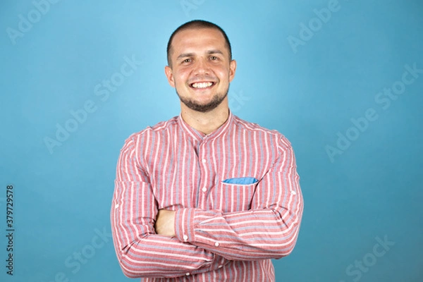 Fototapeta Russian business man over blue background smiling crossing arm and looking at the camera