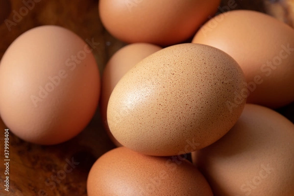 Fototapeta Eggs in a wooden bowl