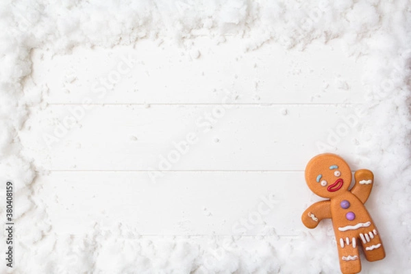 Obraz Top view of gingerman on snowy white wooden table. Top view with copy space