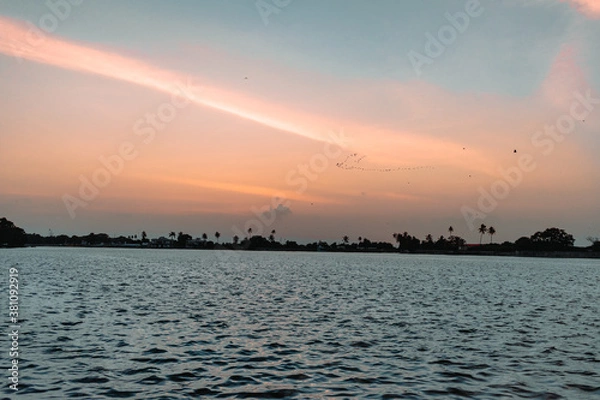 Fototapeta Scenic view of sunset over the lake with beautiful cloudy sky at Hamirasar lake in Bhuj, Kutch, India.