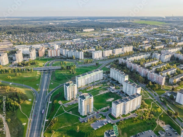 Fototapeta Aerial photography of the city with intersections, roads, houses, buildings, parks and Parking lots on a Sunny day