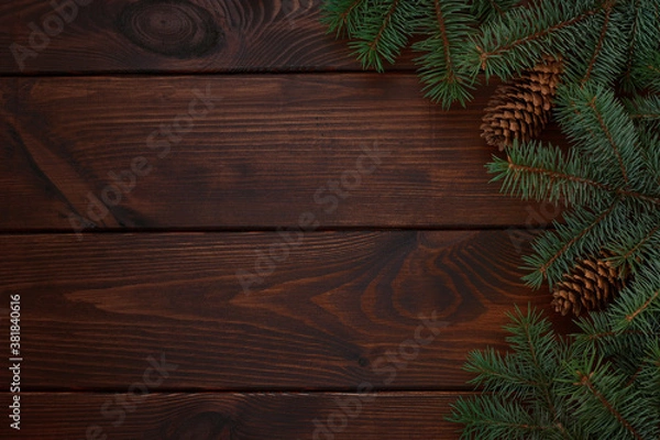 Fototapeta Christmas tree, cones on a wooden brown background.Copy space for your text. Flat lay. New year christmas background