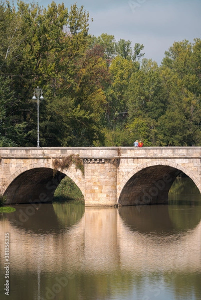 Fototapeta ashlar stone medieval bridge, puente mayor, crossing rio carrion, in autumn. Palencia, Spain.