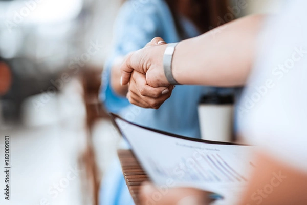 Fototapeta background image of a business handshake at an informal meeting.