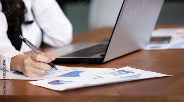 Fototapeta Close up hand business women note job  on graph in business meeting.