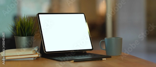 Fototapeta Workspace with mock up digital tablet, keyboard and notebooks on wooden table