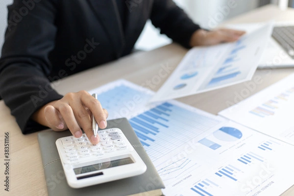 Fototapeta Young Asian women work in financial accounting in a private office at home.