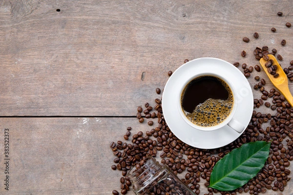 Fototapeta cup of coffee and bean on wooden floor background. top view