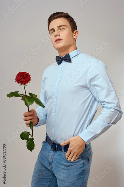 Fototapeta romantic man with red rose and light shirt pants suit