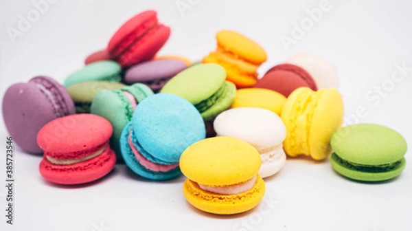 Fototapeta pastel colored macarons isolated on white background.