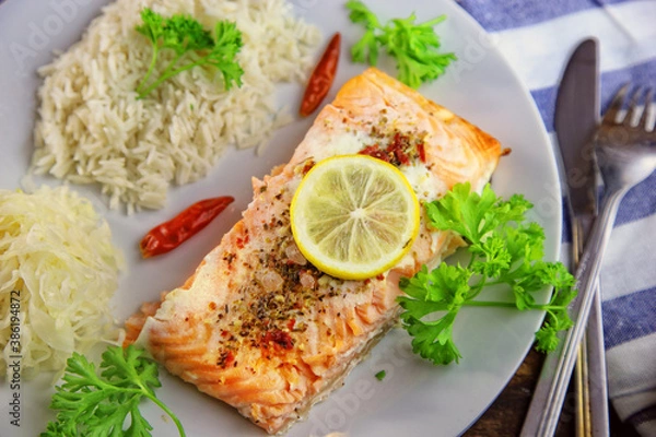 Fototapeta healthy baked fish salmon with rice and sauerkraut