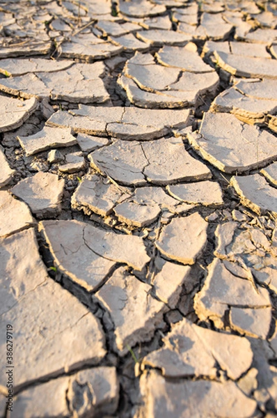 Fototapeta Dry land texture, deep crack. Cracked ground background. Effects of heat and drought. effects of global warming. 