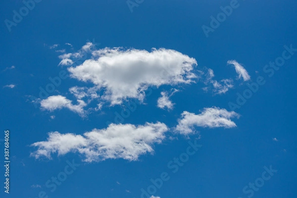 Fototapeta large puffy cumulus clouds bright blue sky