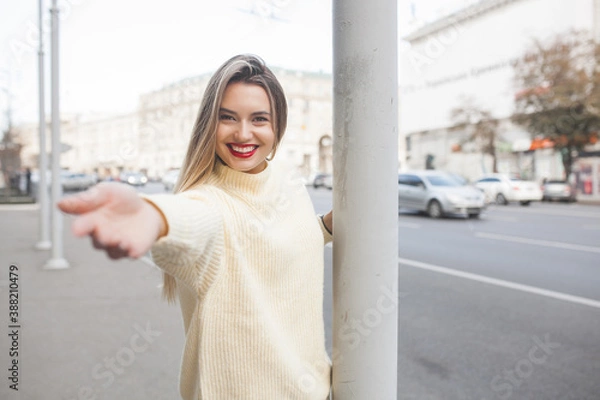 Fototapeta Attractive young woman on urban background.