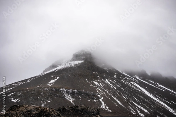 Fototapeta Fog over snow covered mountains in iceland