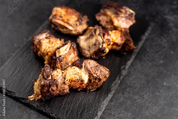 Fototapeta grilled beef ribs on a stone background