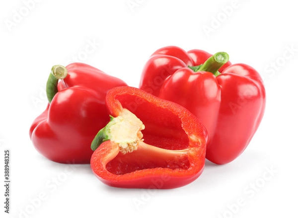 Fototapeta Whole and cut red bell peppers on white background