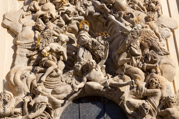 Fototapeta PRAGUE, CZECH REPUBLIC - OCTOBER 18, 2018: Baroque relief of St. Anthony of Padua over the side entry  of  Bazilika Svatého Jakuba Většího (James the Greater) by Ottavio Mosto (1695 -1701).