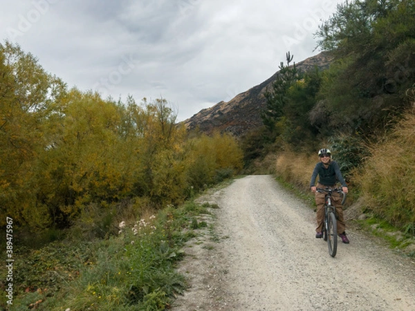 Fototapeta Biking on the Twin Rivers Trail toward the Shotover Bridge, Queenstown Area, South Island, New Zealand