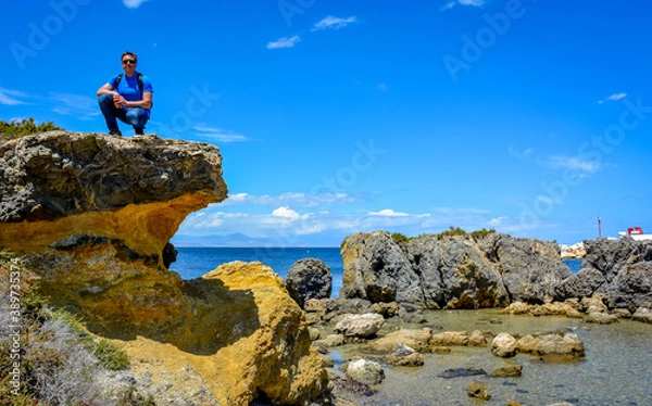 Fototapeta Mature man resting on the sea coast