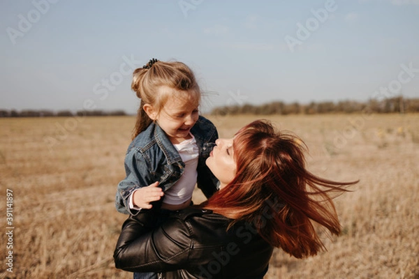 Obraz Mother walking outdoors with her little daughter