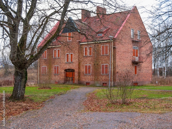 Fototapeta Abandoned brick house in a garden