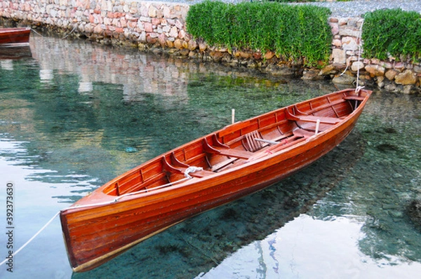 Fototapeta Row boat on very clear sea and its reflection