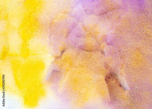 Fototapeta Yellow and purple paint on the snow in winter.