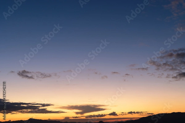 Fototapeta Sunset background with wonderful golden yellow sky,