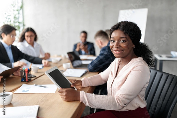 Obraz African American Businesswoman Using Tablet On Corporate Meeting In Office