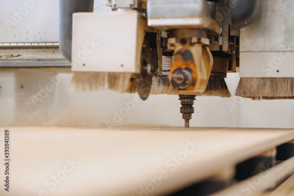 Fototapeta Closeup shot of an industrial working plywood carving machine