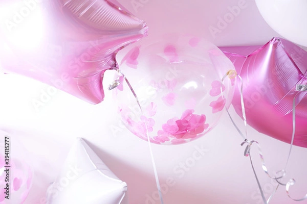 Obraz Pink, white and transparent balloons with rose petals inflated with helium on a white background