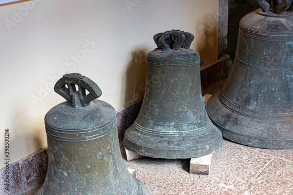 Fototapeta detail of old bells of a steeple. These are on the ground