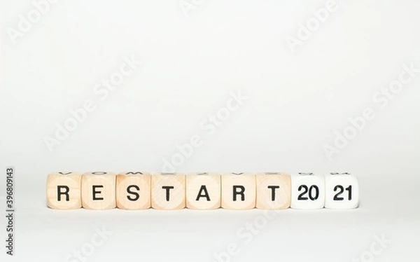 Fototapeta restart 2021 written with letter cubes on white background