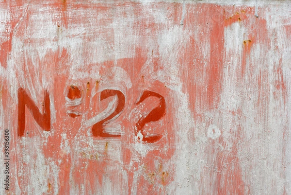 Fototapeta Number 22 sprayed on wall graffiti red on red and grey rust texture