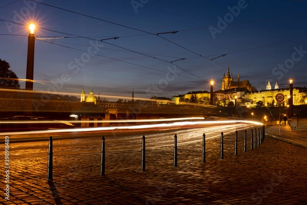 Fototapeta Scenic view of illuminated Prague skyline seen from Mánes bridge. Traffic light trails in the twilight