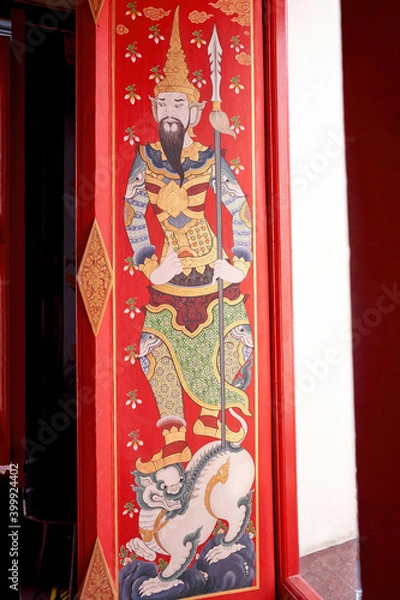 Fototapeta Chinese painting art on temple window The gods and lions patterns are brightly colored.