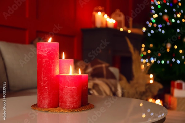 Fototapeta Burning candles in living room decorated for Christmas