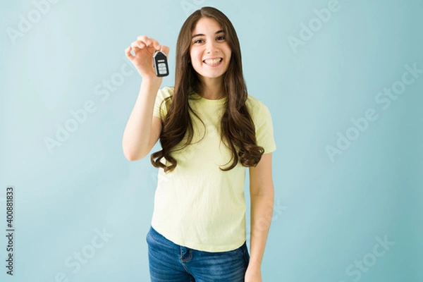 Fototapeta Pretty woman in her 20s with a big smile is showing her car keys