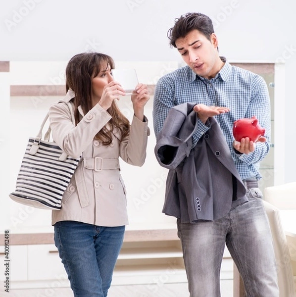 Fototapeta Young couple saving money for new furniture