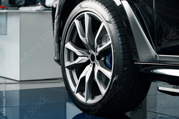 Fototapeta Aluminium rim of luxury car wheel close up