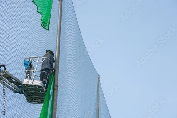 Fototapeta The worker on a construction site