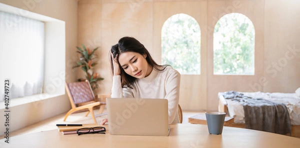 Fototapeta Portrait of stress sad business woman working alone at home office. Business woman work hard lifestyle stress burnout overtime office syndrome, work from home, quarantine coronavirus concept.