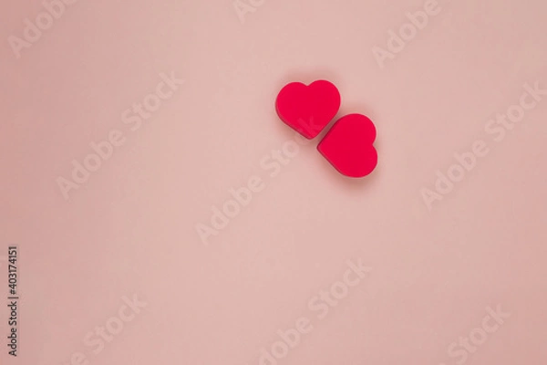 Fototapeta  two red hearts on a pink background