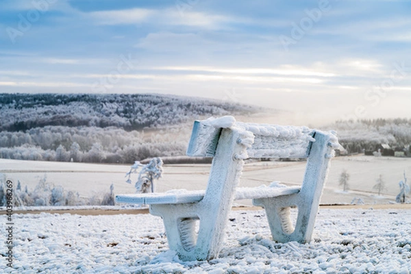 Fototapeta Winter mountains landscape and wooden iced bench in the morning