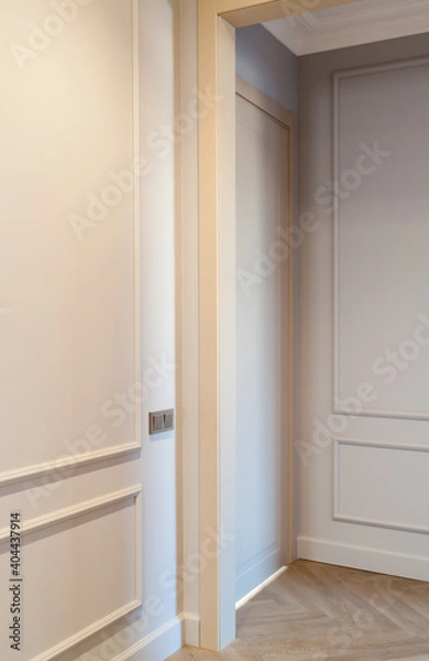 Fototapeta Close up view of modern and bright interior of empty cream colored corridor with herringbone parquet floor