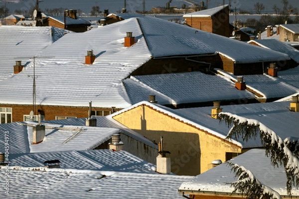 Fototapeta Snowed roofs at sunrise, after a blizzard