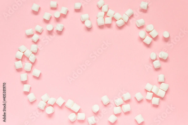 Fototapeta Marshmallow frame on a pink background. Concept of love, happy valentine's day, women's day and birthday celebration. Flatly, copy space, mock up, banner.