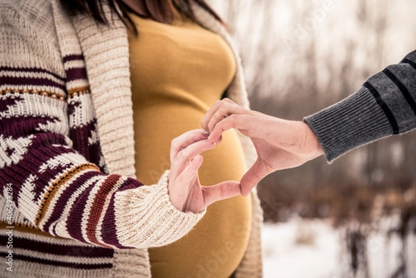 Fototapeta woman and man forming a heart with hands