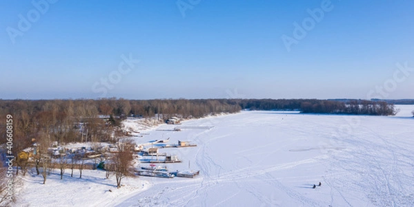 Fototapeta Snowy forest top view, sunny frosty day. Spruce and pine trees from above.